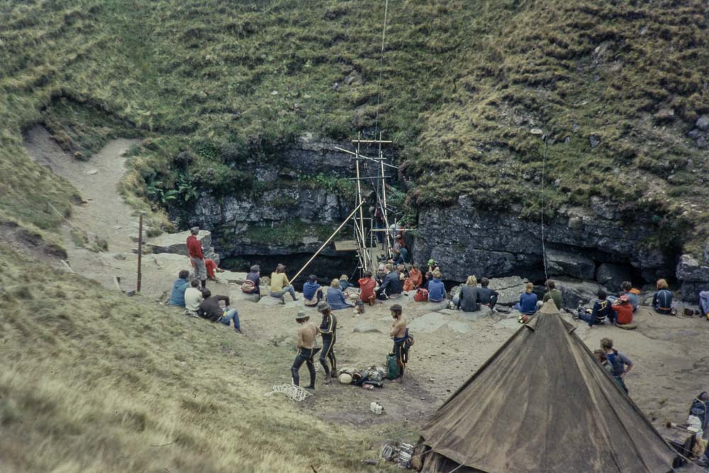 scaffolding erected over Gaping Gill shaft with people waiting to descend 1975