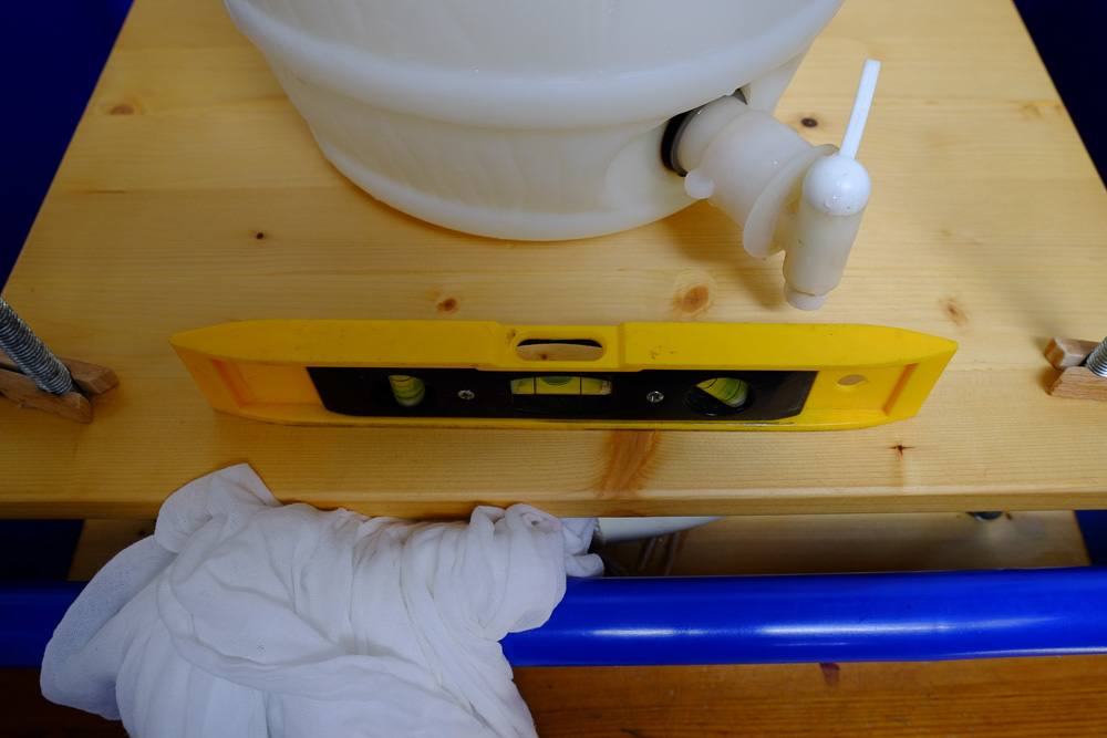 Home made wooden cheese press with a spirit level.