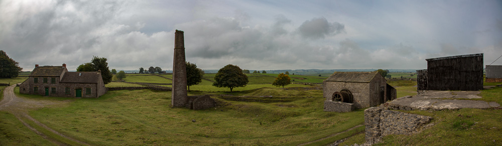 Remains of Magpie Mine buildings, the agent's house, a chimney, a winding wheel and sheds.