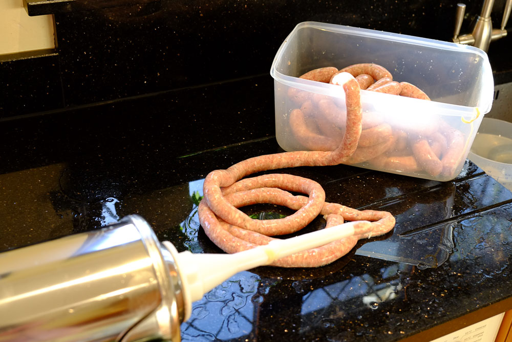 Sausages being made, skins being stuffed from a stuffer