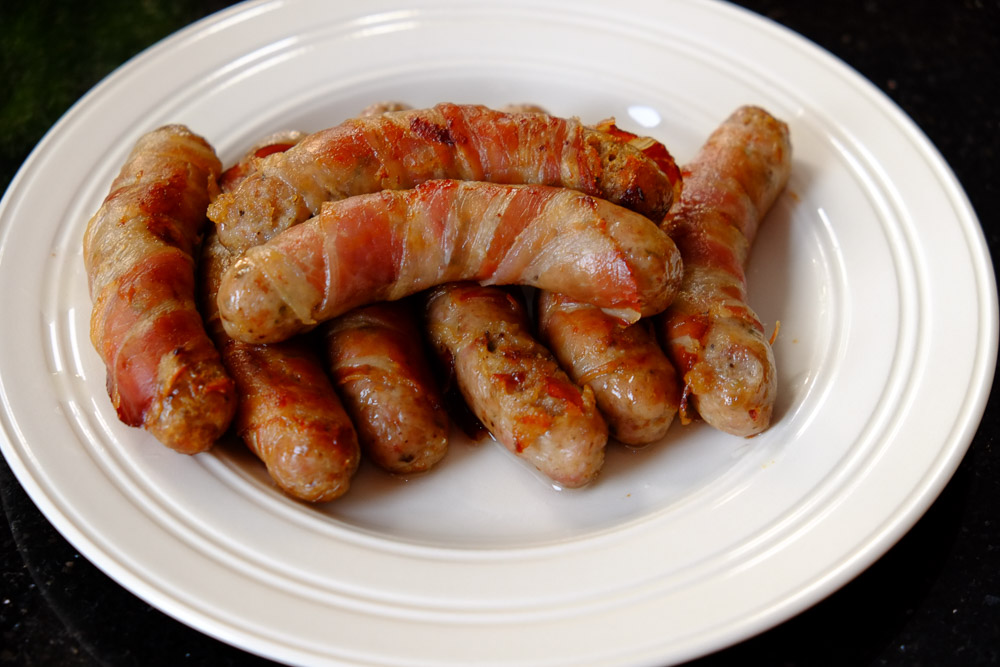 Pigs in blankets, chipolata sausages wrapped in pancetta and oven baked.