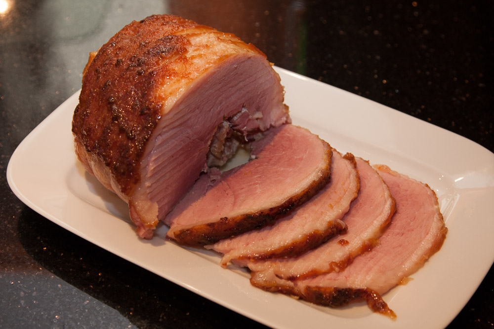 baked and sliced ham on a serving plate