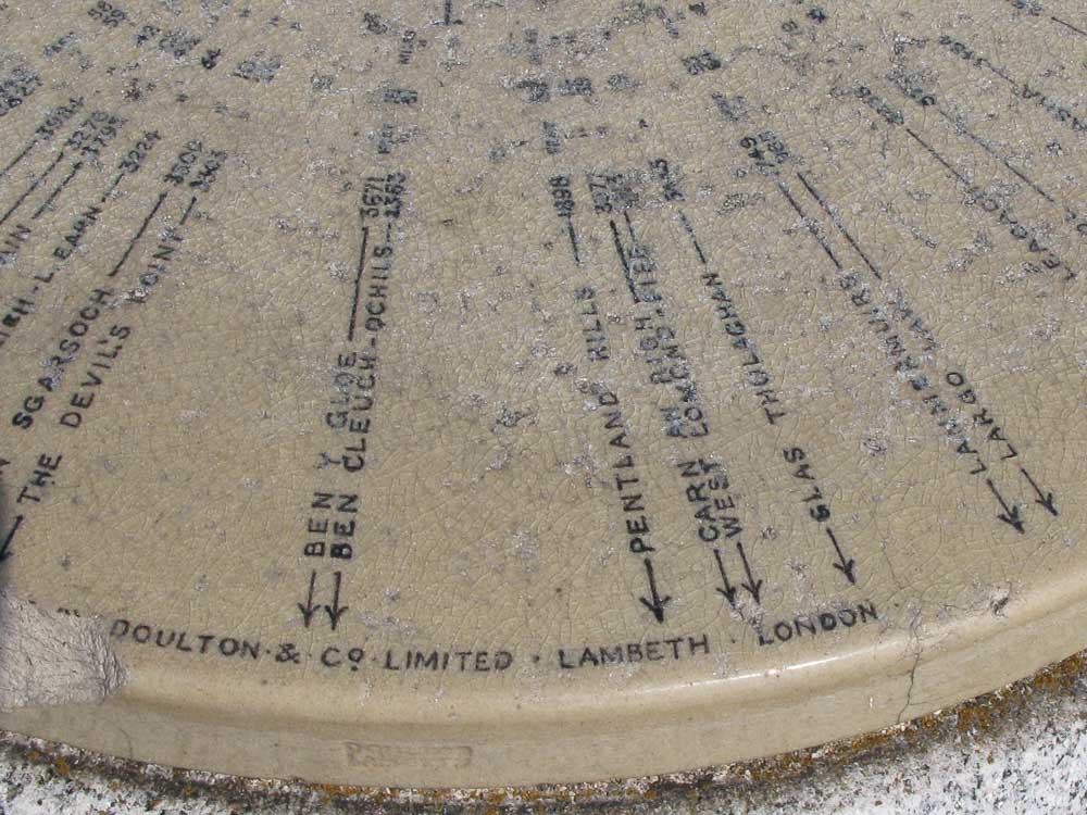 A ceramic plaque on the summit of Ben Macdui indicating all the summits and landmarks 360 degrees around. Doulton and Co. limited Lambeth London can be seen on one edge of the plaque.