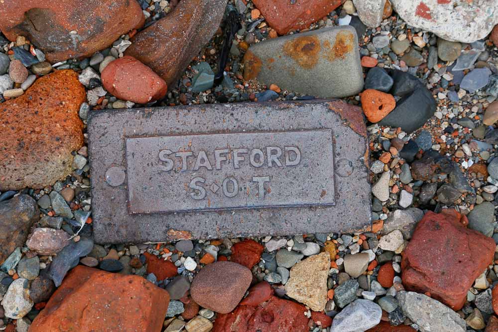 A grey brick with the word Stafford S O T embossed in the surface